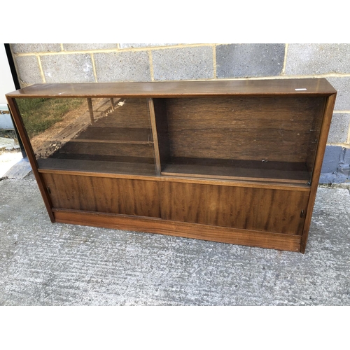 10 - A 1950's glazed bookcase cabinet 152w x 24d x 84h