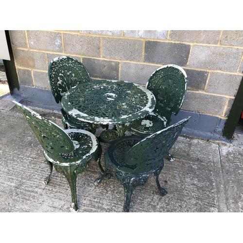14 - An aluminium garden table and four chairs 70cm diameter