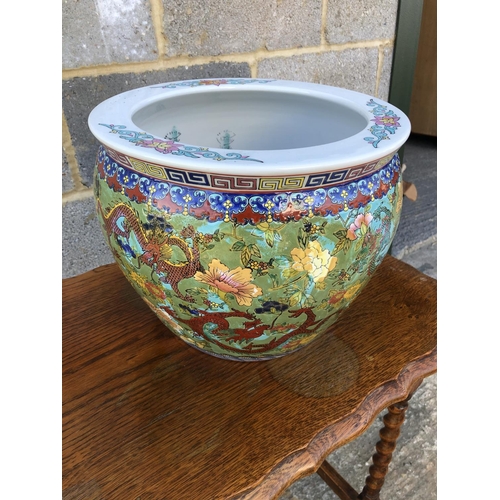 3 - A reproduction oriental fish bowl decorated with brigt colours 31diameter 26high