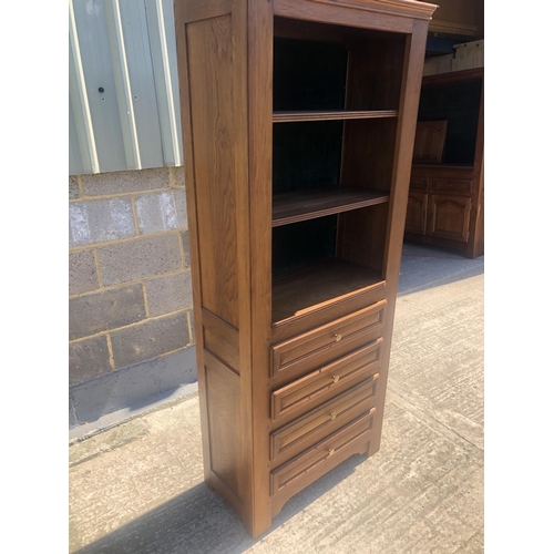 39 - A continental oak bookcase, 4 shelves over 4 drawers 78 x 36 x 190cm