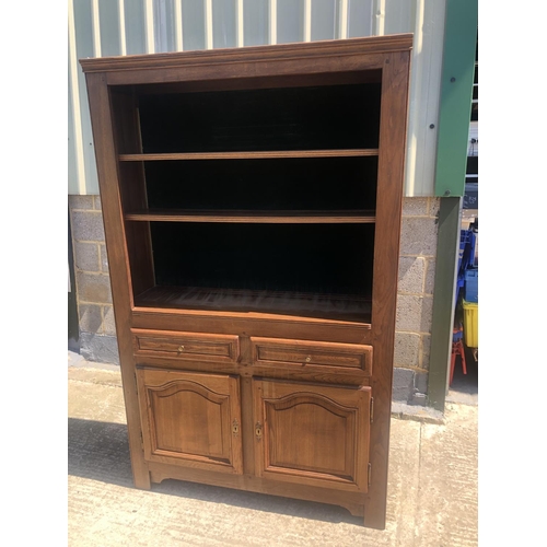 40 - A continental oak bookcase, two shelves over cupboard base 118x 37 x 190cm