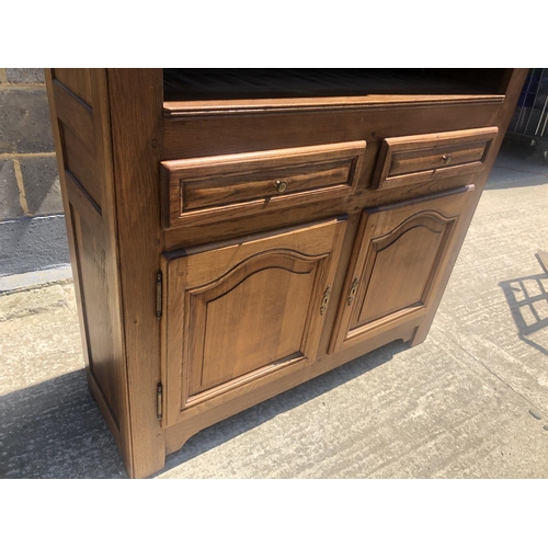 40 - A continental oak bookcase, two shelves over cupboard base 118x 37 x 190cm