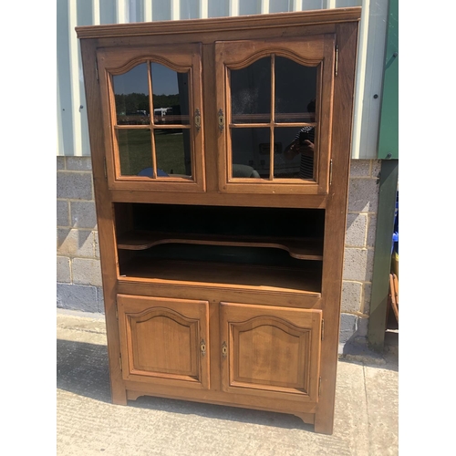 41 - A continental Oak cabinet, glazed cabinet over open shelf over closer cupboard