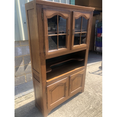 41 - A continental Oak cabinet, glazed cabinet over open shelf over closer cupboard