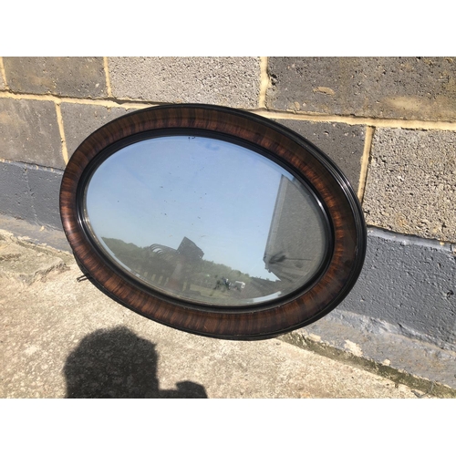 54 - A mahogany framed oval wall mirror