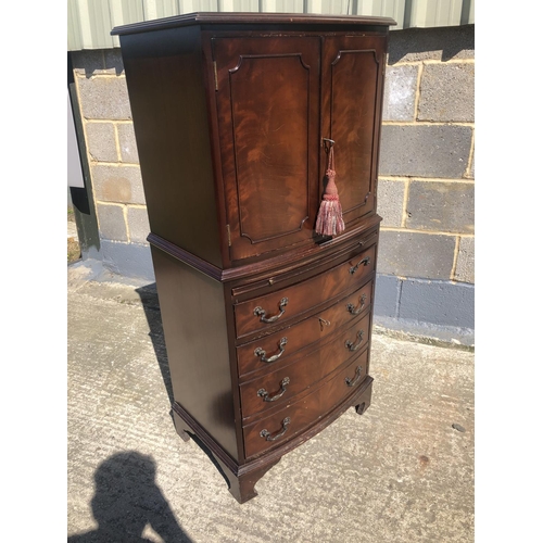 57 - A reproduction mahogany drinks cabinet with fitted mirror interior