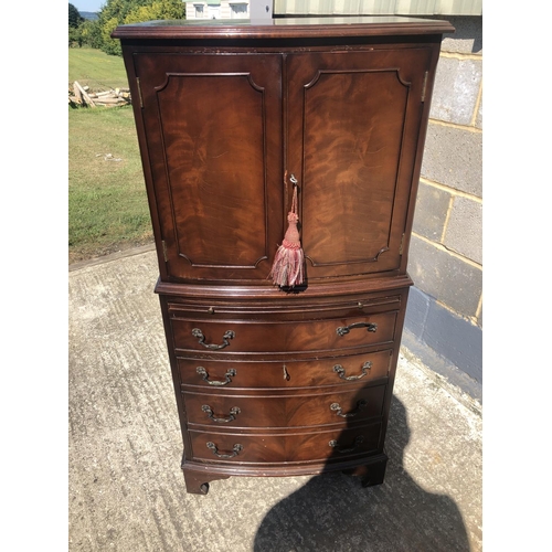 57 - A reproduction mahogany drinks cabinet with fitted mirror interior