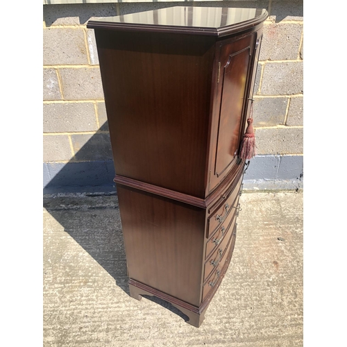 57 - A reproduction mahogany drinks cabinet with fitted mirror interior