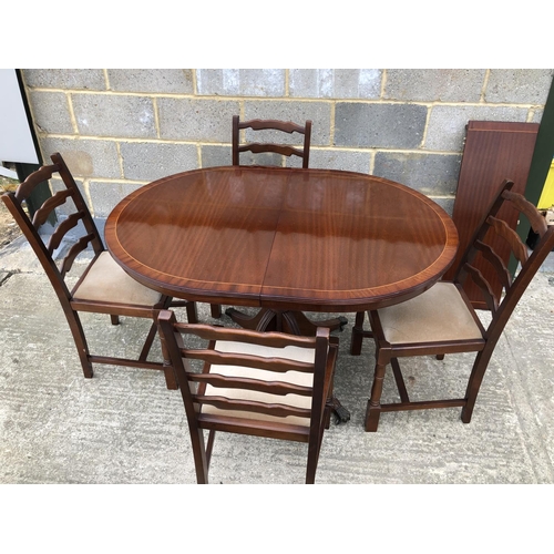 60 - A reproduction mahogany 'd' end dining table with a single extension together with 4 oak chairs