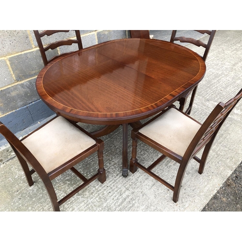 60 - A reproduction mahogany 'd' end dining table with a single extension together with 4 oak chairs
