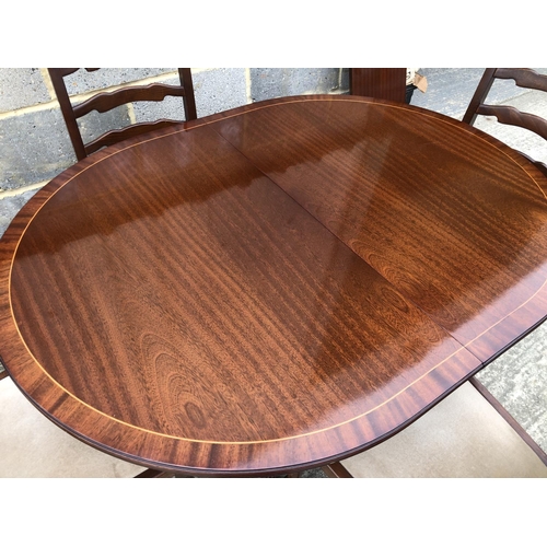 60 - A reproduction mahogany 'd' end dining table with a single extension together with 4 oak chairs