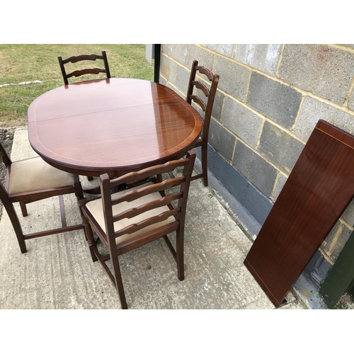 60 - A reproduction mahogany 'd' end dining table with a single extension together with 4 oak chairs