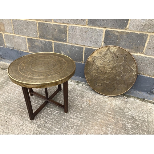 61 - An islamic style brass tray top ocassional base, together with a copper wall hanging plaque 60cm dia... 