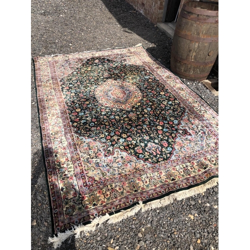 7 - A large patterened carpet. Blue ground with red / pink floral patterns