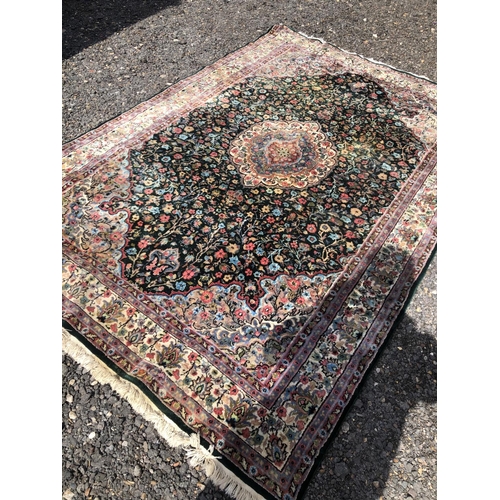 7 - A large patterened carpet. Blue ground with red / pink floral patterns