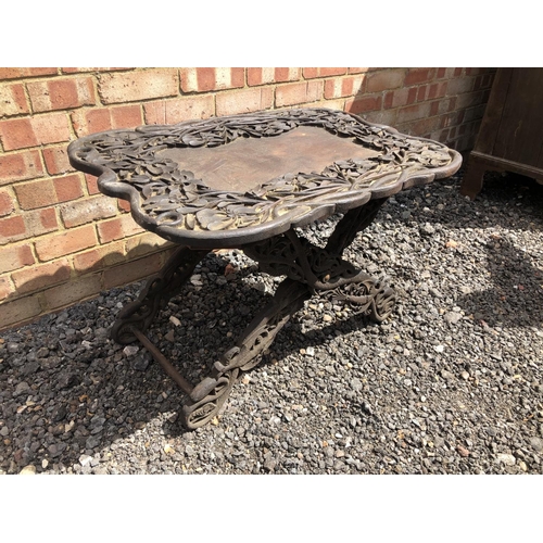 117 - A carved African style tray table on folding x frame base