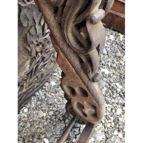 117 - A carved African style tray table on folding x frame base