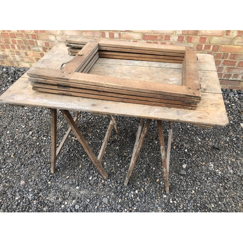 125 - A vintage trestle table together with two extra folding trestles