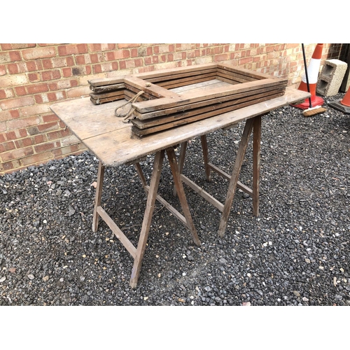 125 - A vintage trestle table together with two extra folding trestles