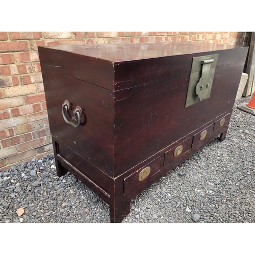 127 - A very large Chinese blanket box chest, lift up lid with brass lock mechanism, over a four drawer ba... 