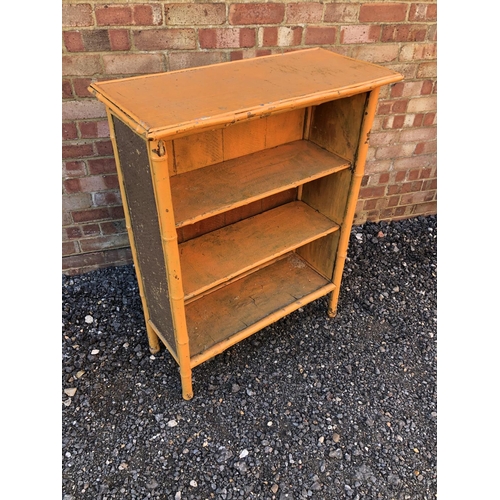 134 - An orange painted bamboo open fronted bookcase