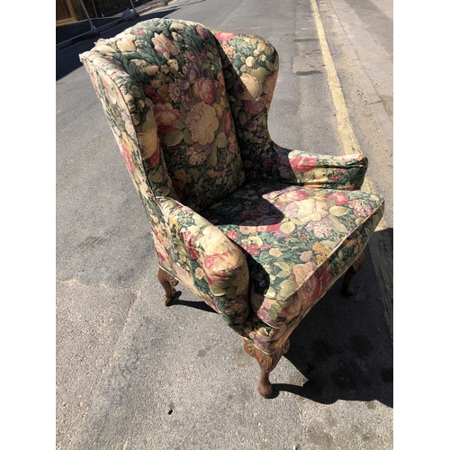 152 - A floral patterned wing armchair