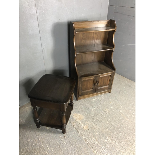 196 - An Ercol waterfall front bookcase together with a matching single drawer occasional table