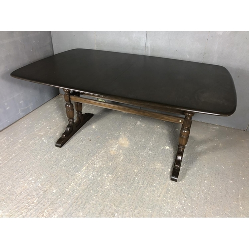 197 - A dark Ercol dining table with two extension leaves 160x100x70 (table closed)