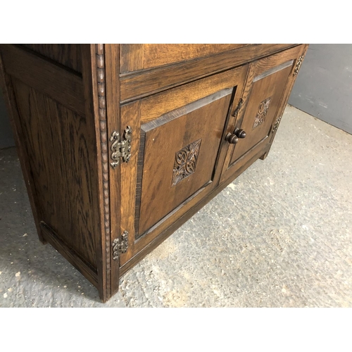 227 - A oak leaded cabinet with two adjustable shelves