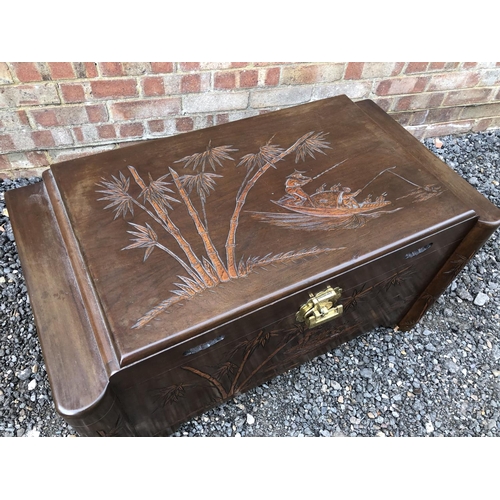 23 - A camphor wood blanket box carved with oriental decoration 92x45x52