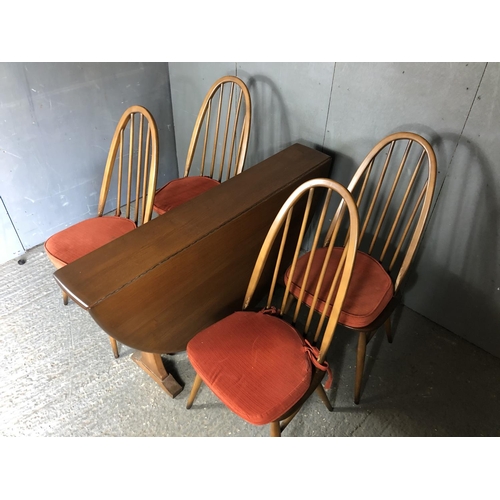 234 - An Ercol golden dawn drop leaf dining table together with four stick back chairs