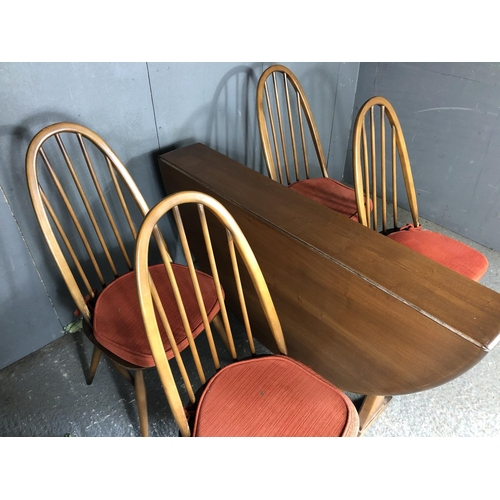 234 - An Ercol golden dawn drop leaf dining table together with four stick back chairs