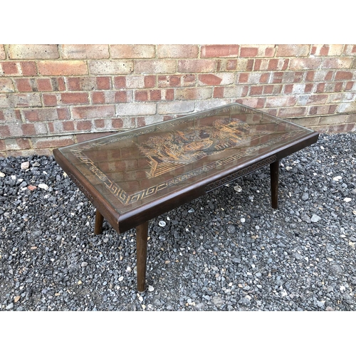 24 - A camphor wood coffee table with carved decorations and drop in glass top 92x45x40