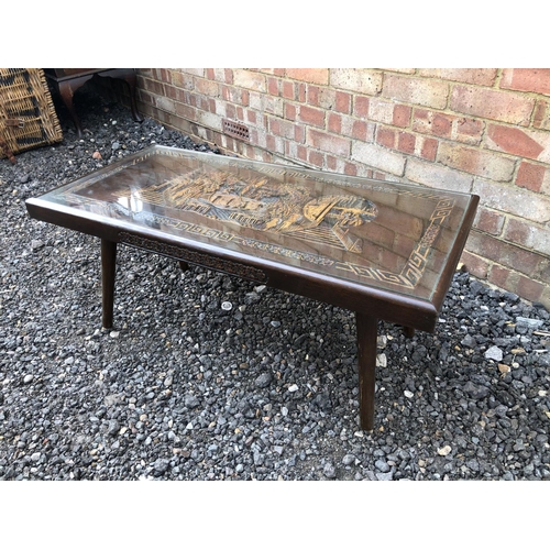 24 - A camphor wood coffee table with carved decorations and drop in glass top 92x45x40