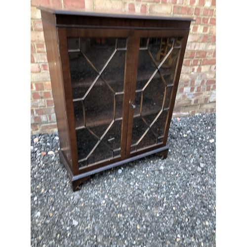 28 - A reproduction mahogany glazed cabinet 85x33x110