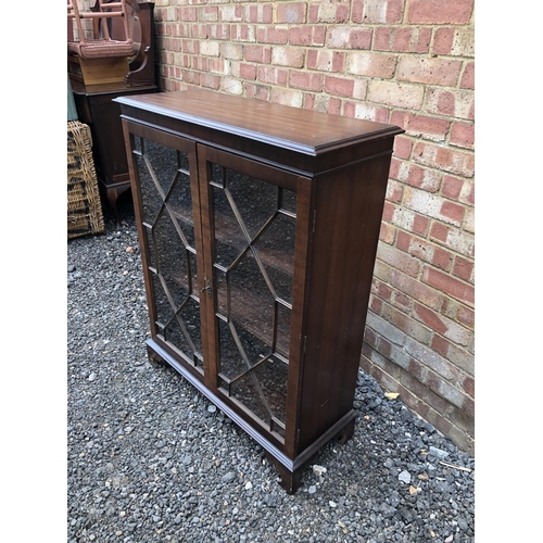 28 - A reproduction mahogany glazed cabinet 85x33x110