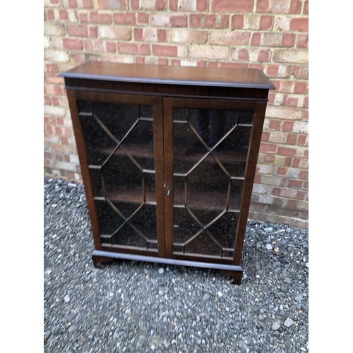 28 - A reproduction mahogany glazed cabinet 85x33x110