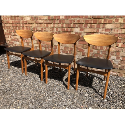 4 - A set of four Teak dining chairs with black vinyl seats