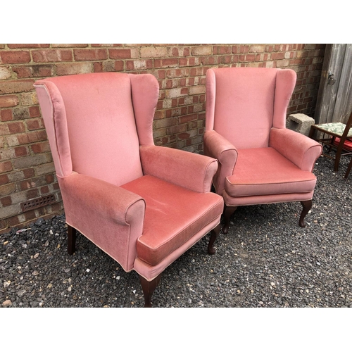 41 - A pair of pink upholstered wing armchairs