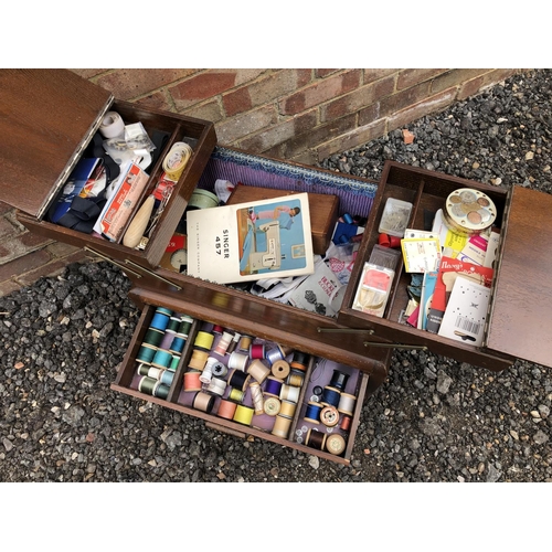 42 - An oak concertina sewing box and contents