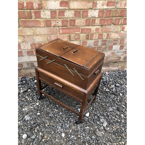 42 - An oak concertina sewing box and contents