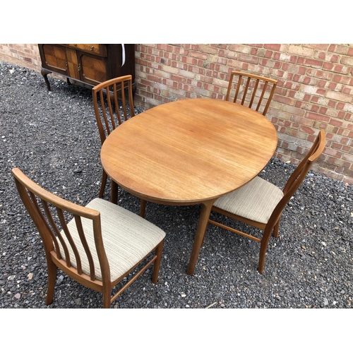 48 - A 1970's oval McIntosh teak dining table together with four chairs