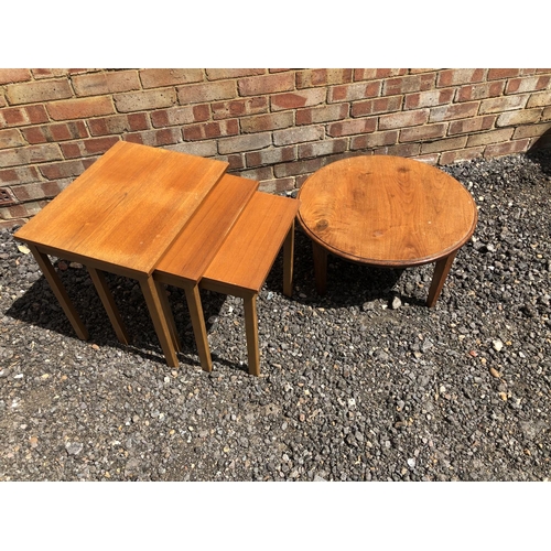 5 - A teak nest of three tables together with a circular coffee table