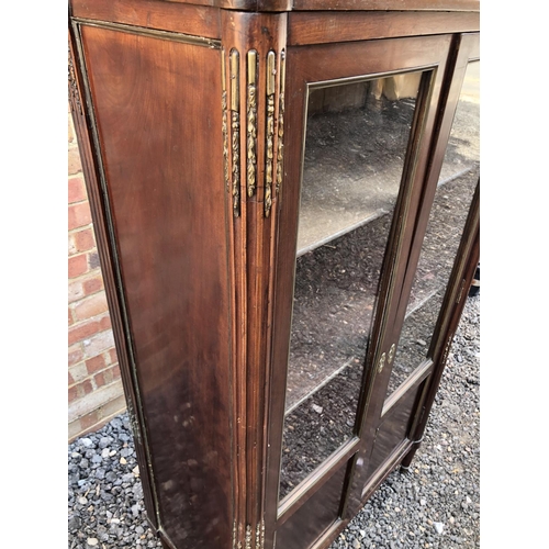 53 - A continental glazed display cabinet with marble inset top, reeed columns with brass mounts 80x40x14... 