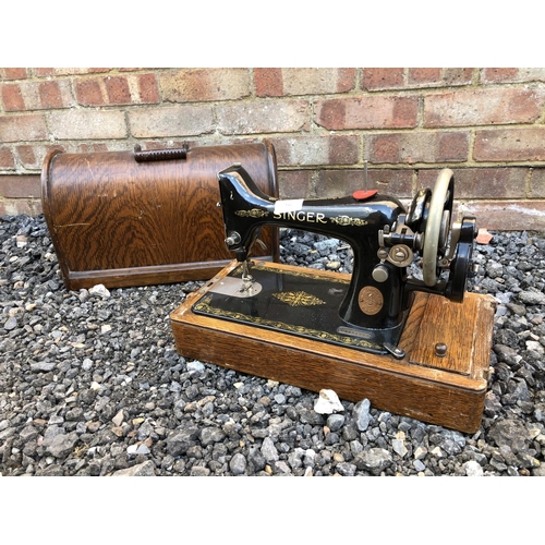 56 - An oak cased singer sewing machine