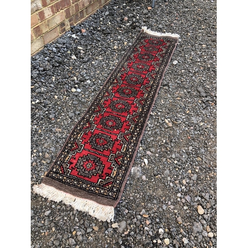 58 - A long red oriental Patterned rug 33x151