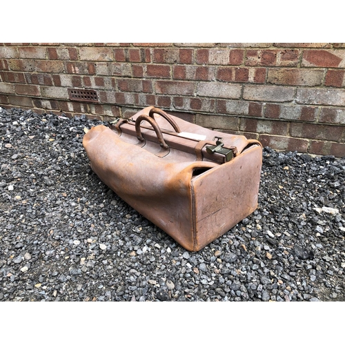 9 - A large vintage brown leather hold-all bag