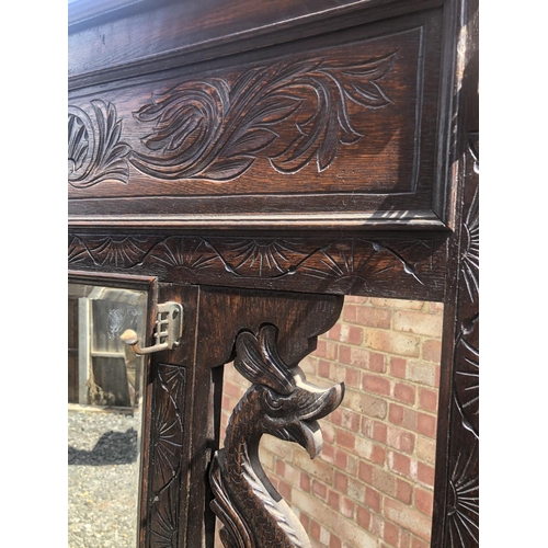 96 - A carved oak hallstand with dragon decoration 102x28x190