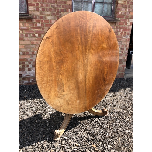 62 - A large circular walnut Loo table stamped for the maker Holland and sons 124cm diameter