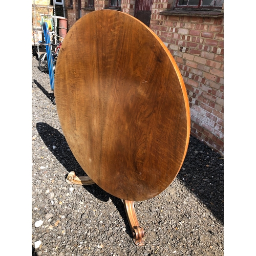 62 - A large circular walnut Loo table stamped for the maker Holland and sons 124cm diameter